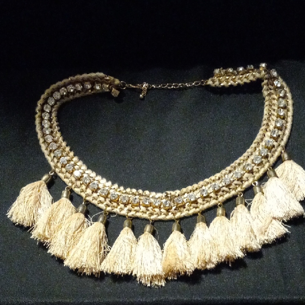 Boho inspired woven over gold with crystals running the length with beige tassel